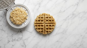 Raw crispy rice and egg waffle batter before cooking, showing rice, egg and almond meal mixed together